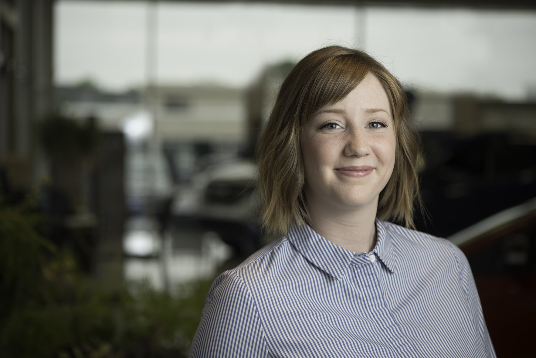 portrait of female employee within auto dealership